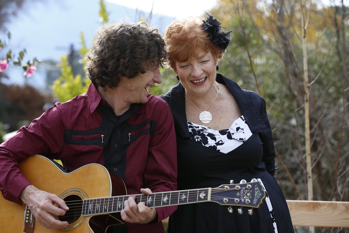 Bill and Rose outdoors together with a guitar