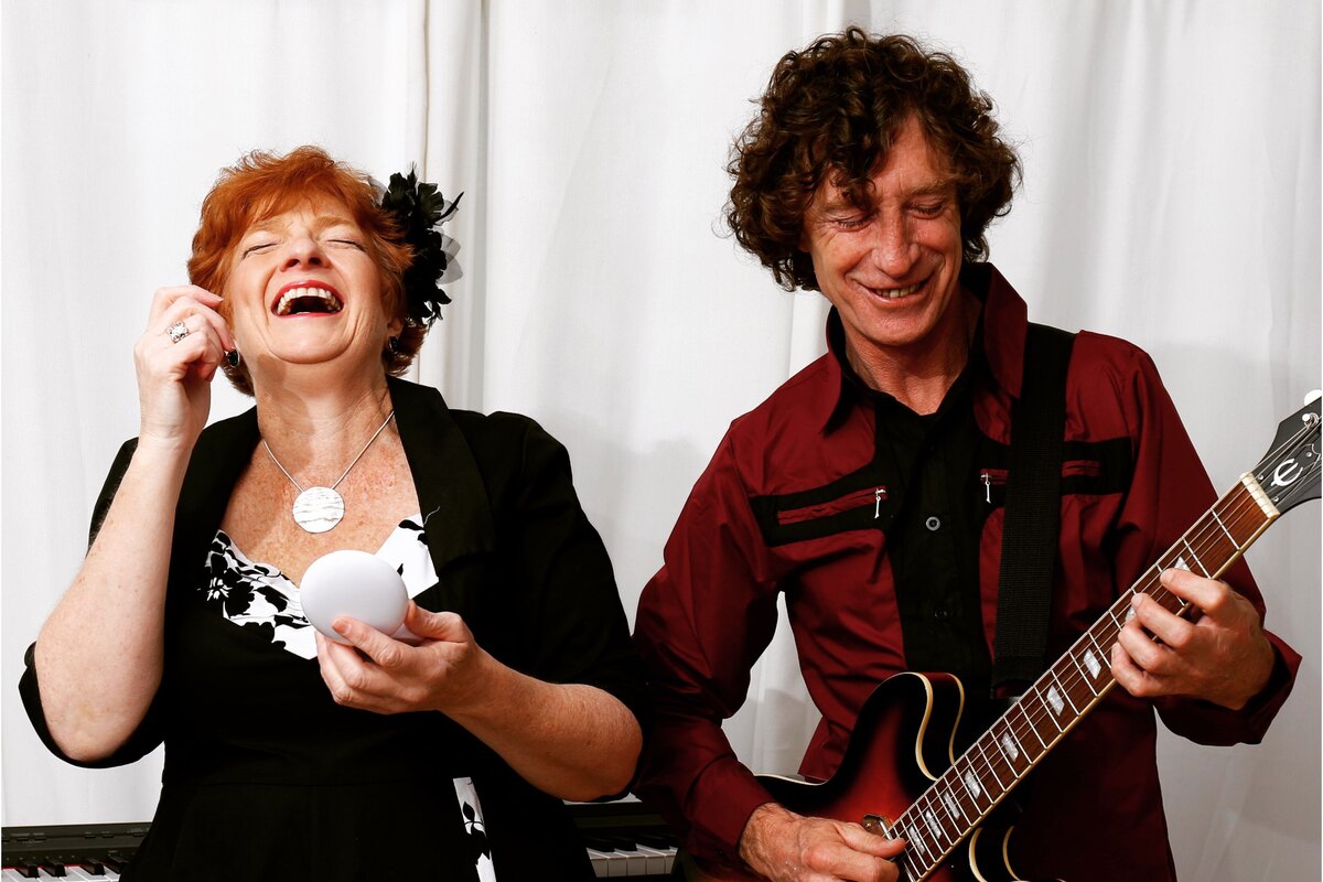 Bill and Rose indoors, laughing together